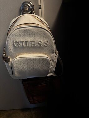 Guess | Bags | Guess Brown Logo Pattern Mini Backpack | Poshmark display picture 1